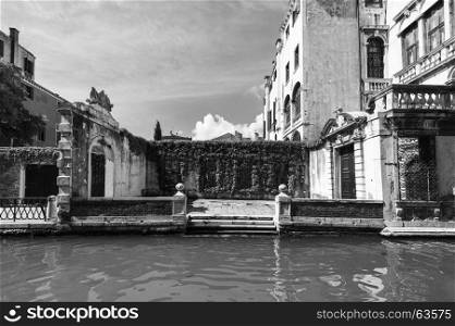 Venice is situated across a group of islands that are separated by canals and linked by bridges. Gondola is a traditional, flat-bottomed Venetian rowing boat. Black and white picture