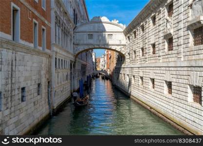 Venice, Italy - 15 October, 2021  gondola with tourists travelling through the narrow canals of the old town of Venice