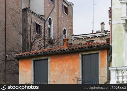 Venice, Italy - April 1, 2013: Street views of canals and ancient architecture in Venice, Italy. Venice is a city in northeastern Italy sited on a group of 118 small islands separated by canals and linked by bridges.