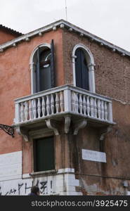 Venice, Italy - April 1, 2013: Street views of canals and ancient architecture in Venice, Italy. Venice is a city in northeastern Italy sited on a group of 118 small islands separated by canals and linked by bridges.