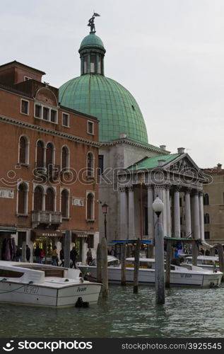 Venice, Italy - April 1, 2013: Street views of canals and ancient architecture in Venice, Italy. Venice is a city in northeastern Italy sited on a group of 118 small islands separated by canals and linked by bridges.