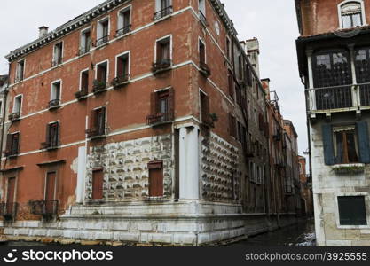 Venice, Italy - April 1, 2013: Street views of canals and ancient architecture in Venice, Italy. Venice is a city in northeastern Italy sited on a group of 118 small islands separated by canals and linked by bridges.