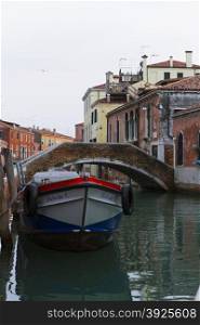 Venice, Italy - April 1, 2013: Street views of canals and ancient architecture in Venice, Italy. Venice is a city in northeastern Italy sited on a group of 118 small islands separated by canals and linked by bridges.