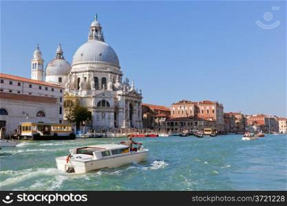 Venice, Italy. Basilica Santa Maria della Salute and Grand Canal. Old Venetian architecture, boats at sunny day