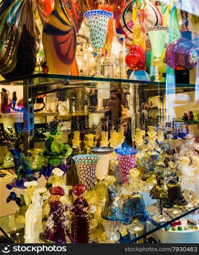 VENICE, ITALY - JUNE 1, 2014: Murano glass on display in window shop in market, Venice. Murano glass is a famous product of the Venetian island of Murano, traditional manufacturing centre.Glass-work in Murano island