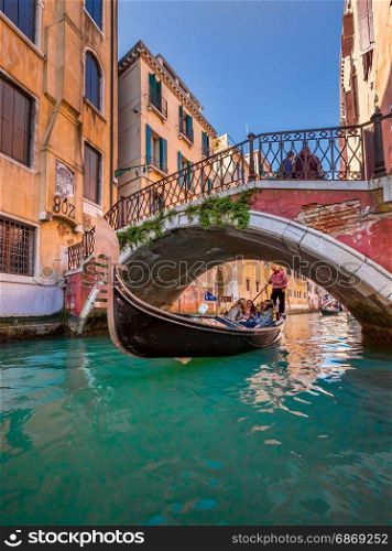 VENICE, ITALY - MARCH 8: Tourists on a Gondola on March 8, 2014 in Venice, Italy. The city has an average of 50,000 tourists a day and it?s one of the world?s most internationally visited city.