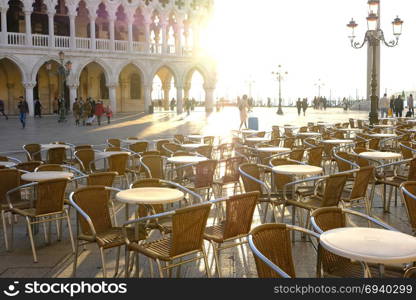 VENICE, ITALY - OCTOBER 26, 2017: Tourists walking at sunny Piazza San Marco in Venice