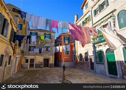 Venice Italy street with laundry washed clothes hanging out to dry on ropes