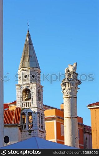 Venice lion on top of the column and church steeple in Zadar