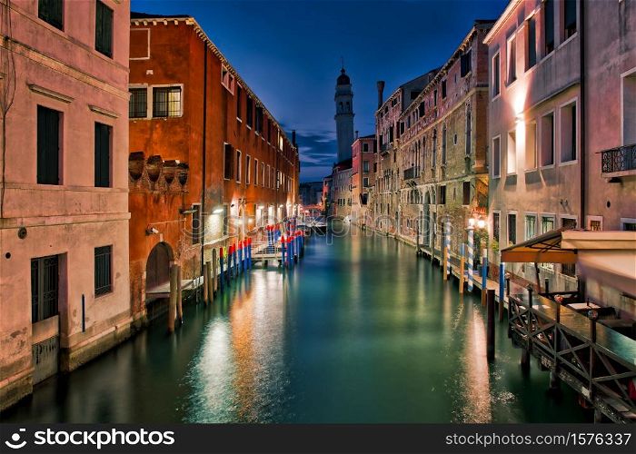 Venice. night view of a lagoon canal with a belfry of a hanging church.