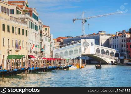 VENICE - NOVEMBER 22: Gondola with tourists on November 22, 2015 in Venice, Italy. The gondola is a traditional, flat-bottomed Venetian rowing boat, well suited to the conditions of the Venetian lagoon.