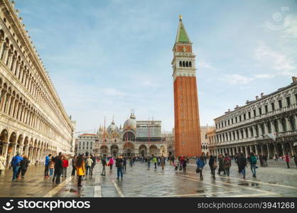 VENICE - NOVEMBER 22: San Marco square with tourists on November 22, 2015 in Venice, Italy. It&rsquo;s the principal public square of Venice, Italy, where it is generally known just as the Piazza.