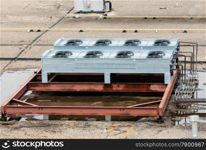 Ventilation fans and machinery on flat roof top.