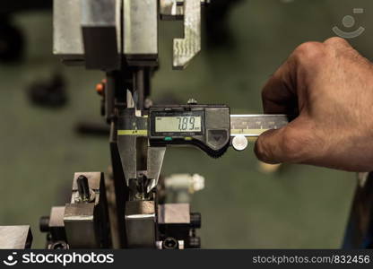 Vernier caliper measure part of jig fixture in factory