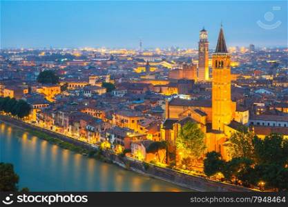 Verona skyline with river Adige, Santa Anastasia Church and Torre dei Lamberti or Lamberti Tower at night, view from Piazzale Castel San Pietro, Italy
