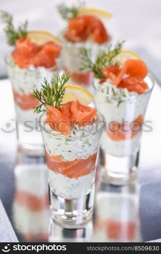 Verrine  from soft cheese cream and salmon, dill sprig and lemon slice. Aperitif appetizer.