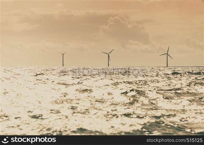 Vertical axis wind turbines generator farm for renewable sustainable and alternative energy production along coast baltic sea near Denmark. Eco power, ecology.. Wind turbines farm in Baltic Sea, Denmark