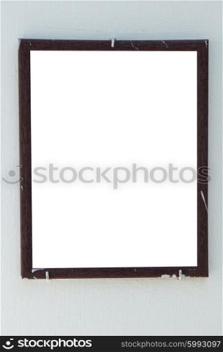 Vertical blank old wooden frame on the wall isolated on white