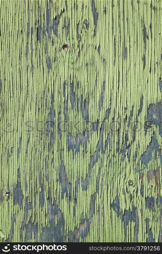 vertical board with peeling green and blue paint