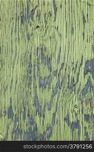 vertical board with peeling green and blue paint