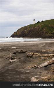 Vertical composition of beach below bluff that holds the North Head Lighthouse