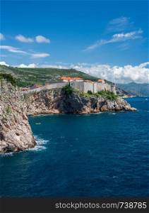 Vertical format of the city walls of the old town in Dubrovnik and coastline. Vertical view of city walls of the old town of Dubrovnik in Croatia