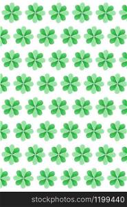 Vertical holiday background from green natural clover plant with four petals handmade from colored paper on a white background. Happy St.Patrick &rsquo;s Day concept.. St.Patrick &rsquo;s Day creative background from clover&rsquo;s leaves.