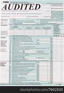 Vertical image of individual income tax form with the word, in large letters, audit. Business financial concept for tax purposes.