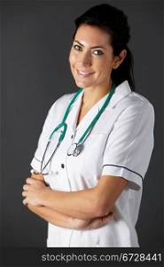 vertical,indoors,studio shot,portrait,black background,nurse,health service,hospital,medical,healthcare,uniform,white,stethoscope,half length,front view,looking at camera,arms folded,smiling,people,one person,female,woman,caucasian,adult,30s,thirties,american,usa