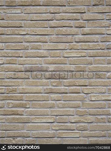 vertical part of yellow creme brick wall with cement joints
