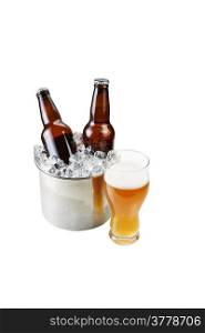 Vertical photo of freshly poured beer in large glass and bottled beer in stainless steel bucket filled with ice isolated on white