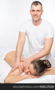 Vertical portrait of a masseur and a young girl patient