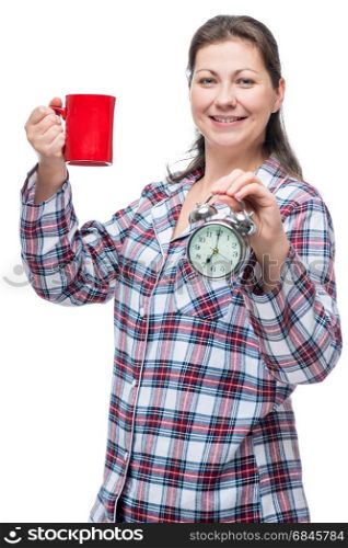 Vertical portrait of a woman in pajamas with a cup of tea with a. Vertical portrait of a woman in pajamas with a cup of tea with an alarm clock, isolated portrait