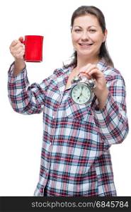 Vertical portrait of a woman in pajamas with a cup of tea with a. Vertical portrait of a woman in pajamas with a cup of tea with an alarm clock, isolated portrait