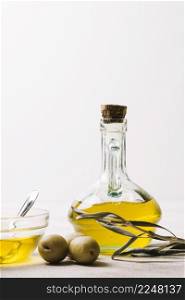 vertical shot olive oil bottle with olives