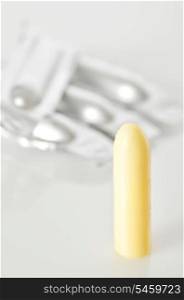vertical suppository on white background, close-up