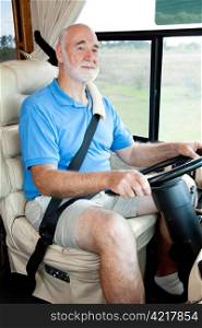 Vertical view of a senior man driving his motor home.