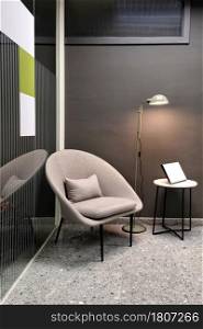 Vertical view of comfortable armchair in office with modern interior design.