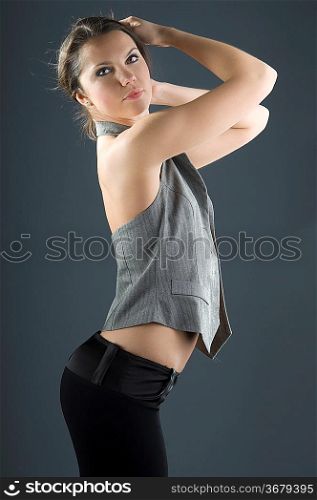 very attractive girl keeping up her hair on gray background