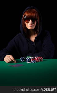 Very beautiful woman playing texas hold&acute;em poker - Low key setup for dramatic ambience