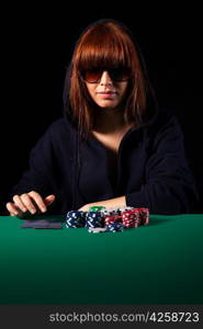 Very beautiful woman playing texas hold&acute;em poker - Low key setup for dramatic ambience