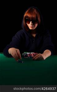 Very beautiful woman playing texas hold&acute;em poker - Low key setup for dramatic ambience
