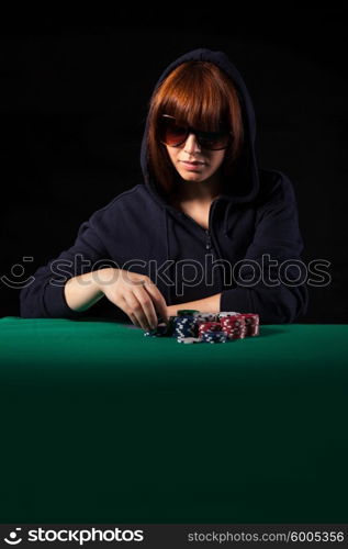 Very beautiful woman playing texas hold&rsquo;em poker - Low key setup for dramatic ambience