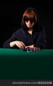 Very beautiful woman playing texas hold&rsquo;em poker - Low key setup for dramatic ambience