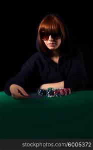 Very beautiful woman playing texas hold&rsquo;em poker - Low key setup for dramatic ambience