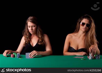 Very beautiful women playing texas hold&acute;em poker