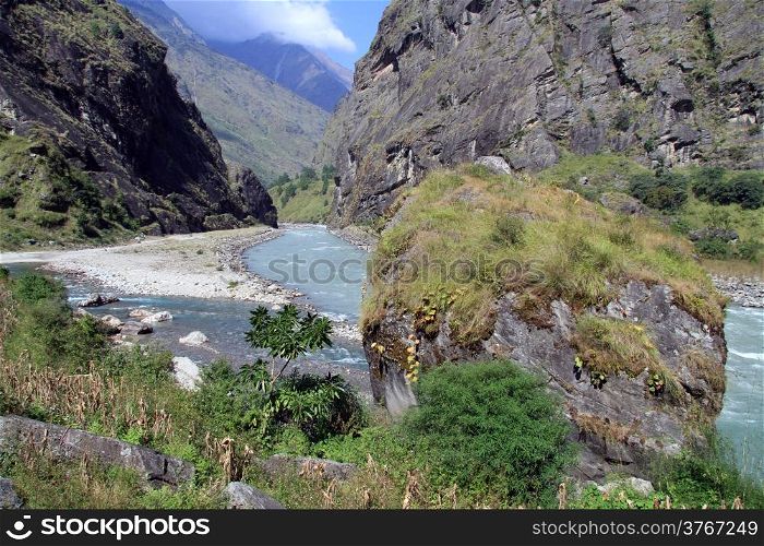 Very big boulder and mountain river in Nepal