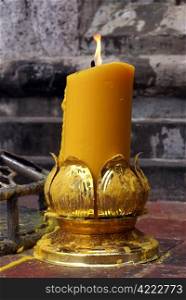 Very big yellow candle near stupa in buddhist temple