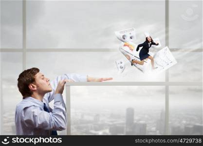 Very busy at office. Businessman looking from under table at miniature of running businesswoman