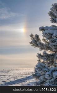 Very cold weather, cloudscape and sun halo in sky. Trakai district municipality, Lithuania